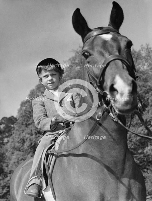 Crown Prince Carl Gustaf of Sweden and his horse, Nivea, Haga Castle, Sweden 1952.  Creator: Unknown.