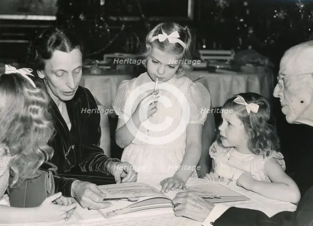 Crown Princess Louise reads a fairy tale to the princesses and King Gustav V of Sweden, 1940s. Creator: Karl Sandels.
