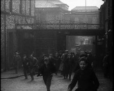 Crowd of Men Walking Through the Street Towards the Camera, 1933. Creator: British Pathe Ltd