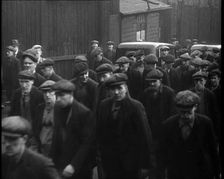 Crowd of Men Walking Through the Street Towards the Camera, 1933. Creator: British Pathe Ltd