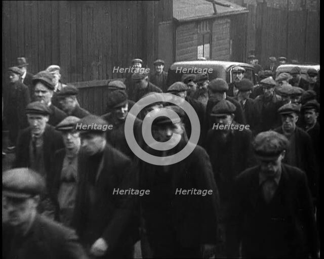 Crowd of Men Walking Through the Street Towards the Camera, 1933. Creator: British Pathe Ltd.