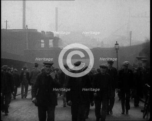 Crowd of Men Walking Through the Street Towards the Camera, 1933. Creator: British Pathe Ltd.