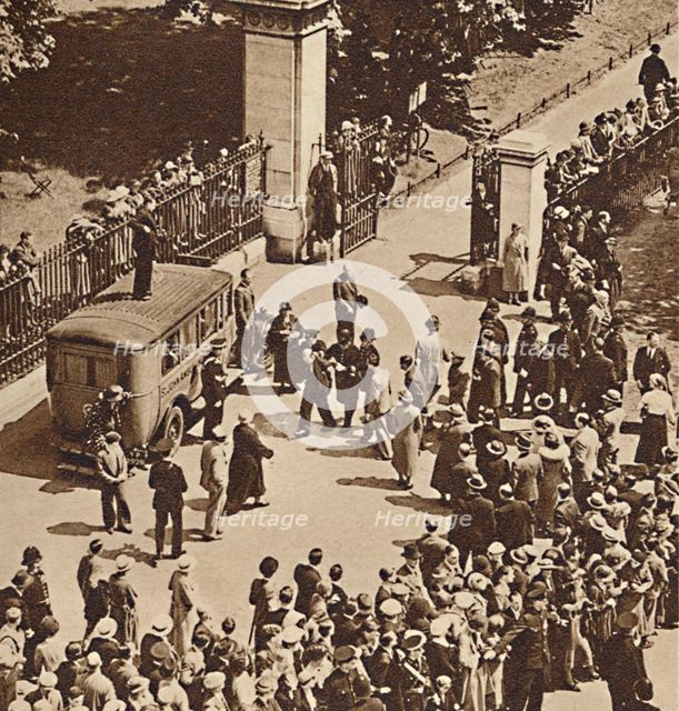 'Crowd watches the arrested man taken to police van', 1937. Creator: Unknown.