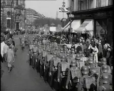 Crowd Watching German Soldiers Marching Down a Street Away from the Camera, 1930s. Creator: British Pathe Ltd