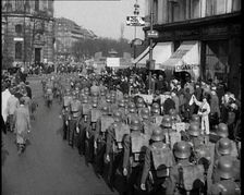 Crowd Watching German Soldiers Marching Down a Street Away from the Camera, 1930s. Creator: British Pathe Ltd