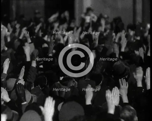 Crowd With Right Arms Raised in a Nazi Salute in the Direction of the..., 1937. Creator: British Pathe Ltd.