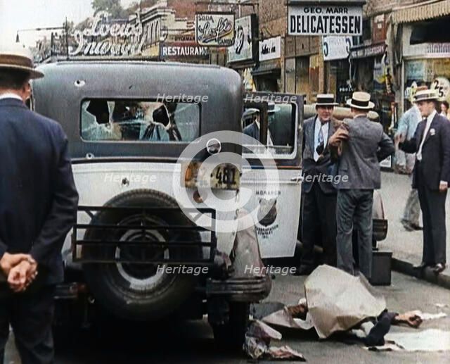 Crowded New York City Street Where Police and Ambulance Attend to Dead and Dying Victims..., 1932. Creator: British Pathe Ltd.