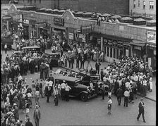 Crowded New York City Street Where Police and Ambulance Attend to Dead and Dying Victims..., 1932. Creator: British Pathe Ltd