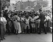 Crowded New York City Street Where Police and Ambulance Attend to Dead and Dying Victims..., 1932. Creator: British Pathe Ltd