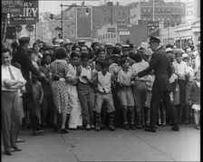Crowded New York City Street Where Police and Ambulance Attend to Dead and Dying Victims..., 1932. Creator: British Pathe Ltd