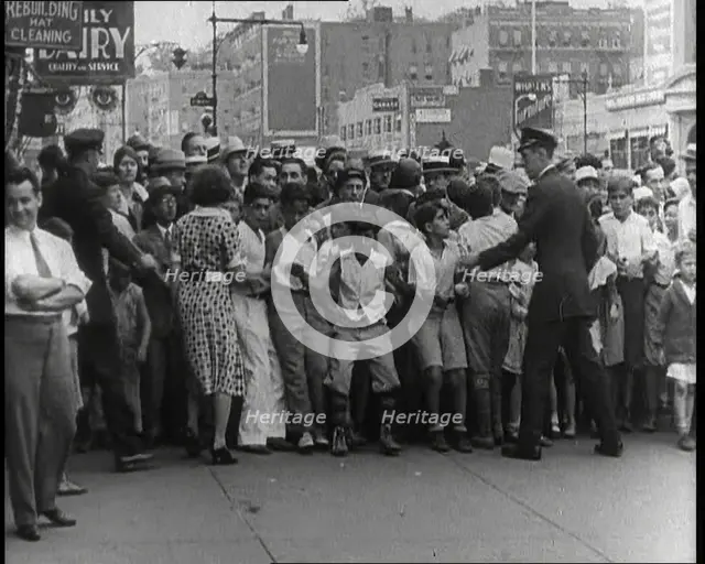Crowded New York City Street Where Police and Ambulance Attend to Dead and Dying Victims..., 1932. Creator: British Pathe Ltd.