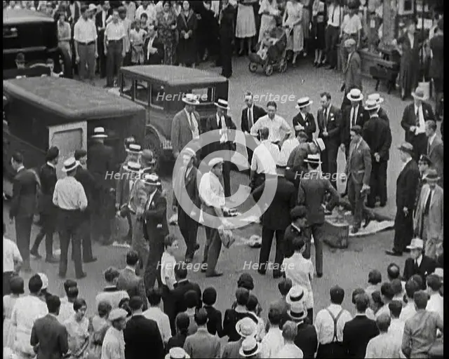 Crowded New York City Street Where Police and Ambulance Attend to Dead and Dying Victims..., 1932. Creator: British Pathe Ltd.