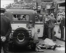 Crowded New York City Street Where Police and Ambulance Attend to Dead and Dying Victims..., 1932. Creator: British Pathe Ltd