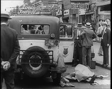 Crowded New York City Street Where Police and Ambulance Attend to Dead and Dying Victims..., 1932. Creator: British Pathe Ltd