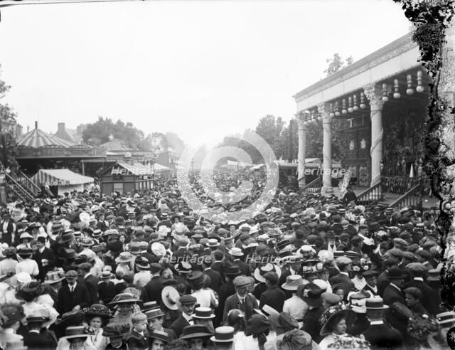 Crowded street showing a stage and carousel at St Giles Fair, Oxford, Oxfordshire, c1860-c1922. Artist: Henry Taunt