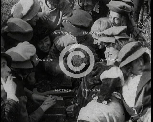 Crowds of Female Actors Wearing Period Costumes Smoking Cigarettes Whilst Filming..., 1920s. Creator: British Pathe Ltd.