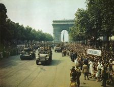 Crowds of French patriots line the Champs Elysees to view Allied tanks and half tracks pass..., 1944 Creator: Jack Downey