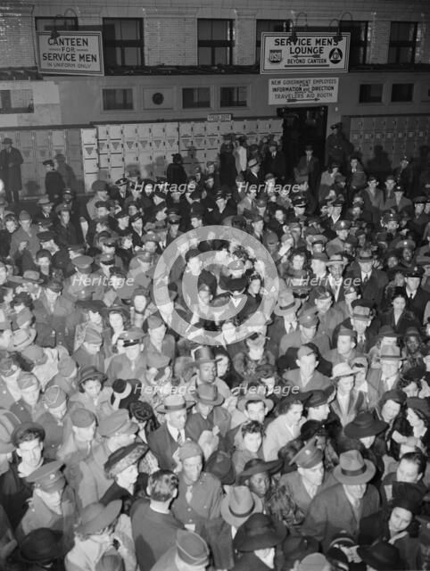 Crowds of soldiers, sailors, and civilians waiting to board trains at..., Washington, D.C., 1942. Creator: Gordon Parks.