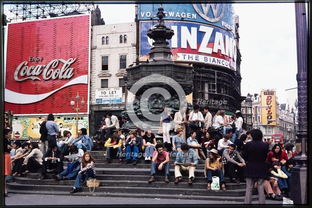 Crowds on the steps at the base of the Shaftesbury Memorial Fountain, Piccadilly Circus, 1974. Creator: Dorothy Chapman.