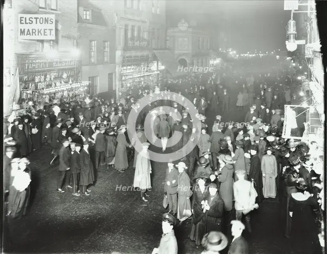 Crowds in Deptford High Street shopping after dark, London, 1913. Artist: Unknown.