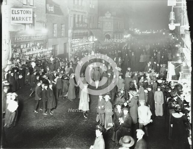 Crowds in Deptford High Street shopping after dark, London, 1913. Artist: Unknown.
