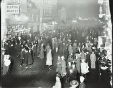 Crowds in Deptford High Street shopping after dark, London, 1913