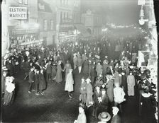 Crowds in Deptford High Street shopping after dark, London, 1913