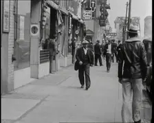 Crowds Walking Down a Pavement, 1930s. Creator: British Pathe Ltd