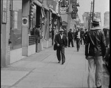 Crowds Walking Down a Pavement, 1930s. Creator: British Pathe Ltd