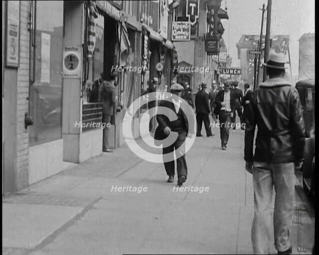 Crowds Walking Down a Pavement, 1930s. Creator: British Pathe Ltd.
