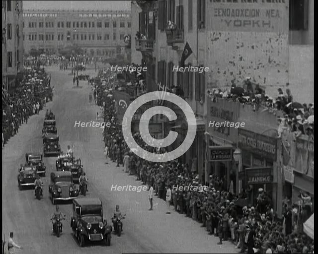 Crowds Watching a Convoy Driving Through the Streets, 1936. Creator: British Pathe Ltd.