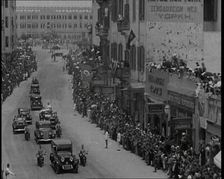 Crowds Watching a Convoy Driving Through the Streets, 1936. Creator: British Pathe Ltd
