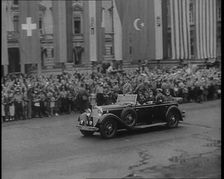 Crowds Watching a Car Drive Through Berlin, 1936. Creator: British Pathe Ltd