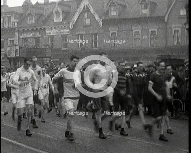 Crowds Watching a Men's Walking Race in the Street, 1920. Creator: British Pathe Ltd.