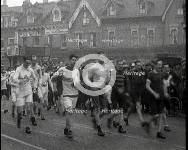 Crowds Watching a Men's Walking Race in the Street, 1920. Creator: British Pathe Ltd.