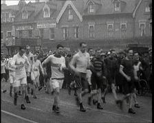 Crowds Watching a Men's Walking Race in the Street, 1920. Creator: British Pathe Ltd