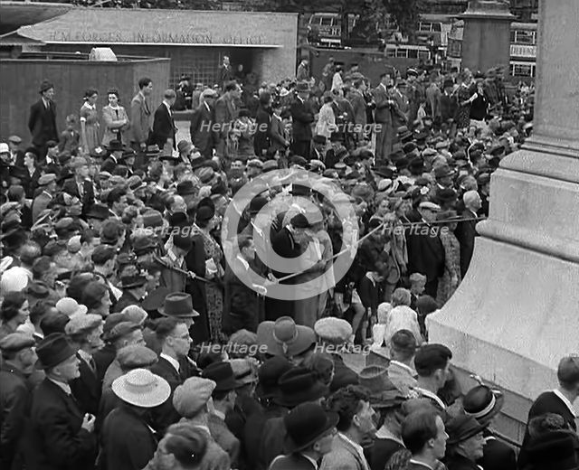 Crowds watching a Military Band in Trafalgar Square, 1940. Creator: British Pathe Ltd.