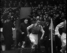 Crowds Watching Football Players Running onto the Football Pitch, 1930s. Creator: British Pathe Ltd