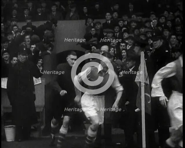 Crowds Watching Football Players Running onto the Football Pitch, 1930s. Creator: British Pathe Ltd.