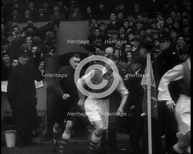 Crowds Watching Football Players Running onto the Football Pitch, 1930s. Creator: British Pathe Ltd.