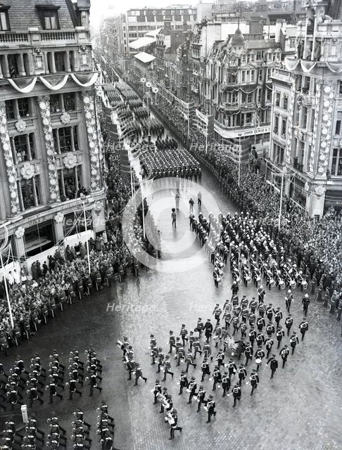 Crowds watching the coronation procession of Queen Elizabeth II, Oxford Circus, London, 2 June 1953. Creator: Arthur Charles Kirby Ware.