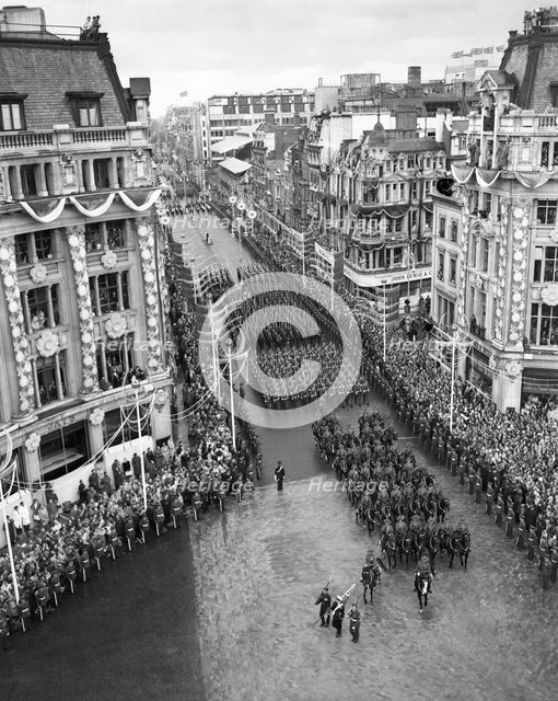 Crowds watching the coronation procession of Queen Elizabeth II, Oxford Circus, London, 2 June 1953. Creator: Arthur Charles Kirby Ware.