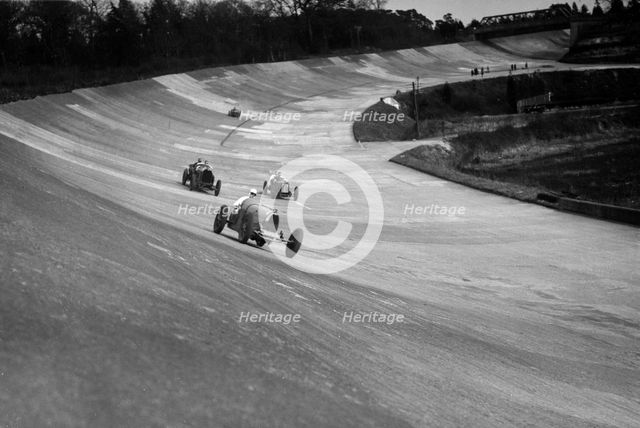 CS Staniland's Bugatti Type 37A leading a Benz and Jack Dunfee's Ballot, Brooklands, 1930. Artist: Bill Brunell.