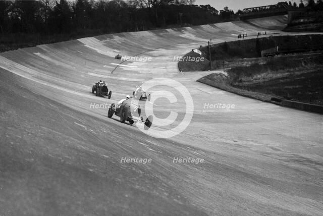 CS Staniland's Bugatti Type 37A leading a Benz and Jack Dunfee's Ballot, Brooklands, 1930. Artist: Bill Brunell.