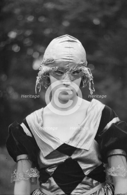 Cutter, Helen, Miss, wearing a mask, 1921 or 1922. Creator: Arnold Genthe.