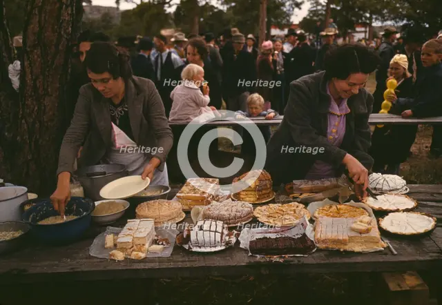 Cutting the pies and cakes at the barbeque dinner, Pie Town, New Mexico Fair, 1940. Creator: Russell Lee.