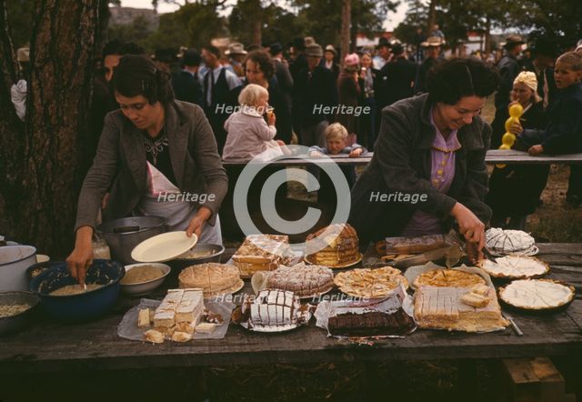 Cutting the pies and cakes at the barbeque dinner, Pie Town, New Mexico Fair, 1940. Creator: Russell Lee.