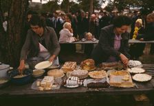 Cutting the pies and cakes at the barbeque dinner, Pie Town, New Mexico Fair, 1940. Creator: Russell Lee