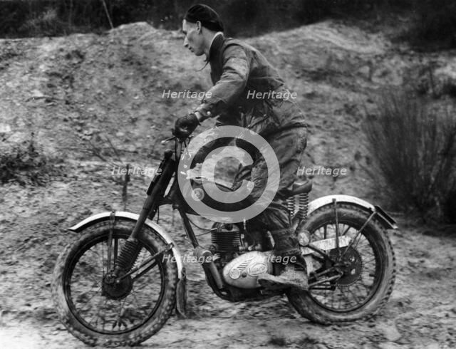 Cullen riding a Francis Barnett bike at the J White Trial. Artist: Unknown