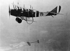 Curtiss JN-4 "Jenny" aircraft with model wing suspended, June 22, 1921. Creator: Unknown